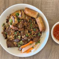 Bun Tom Thit Nuong Cha Gio · Grilled pork, shrimp and egg roll over vermicelli and vegetables.