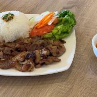 Com Thit Nuong · Grilled sliced pork with steamed rice and vegetables.