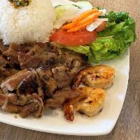 Com Tom Thit Nuong · Grilled sliced pork and shrimp with steamed rice and vegetables.