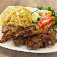 Nui Xao Ga Ro Ti · Grilled boneless chicken thighs served with garlic pasta and vegetables.