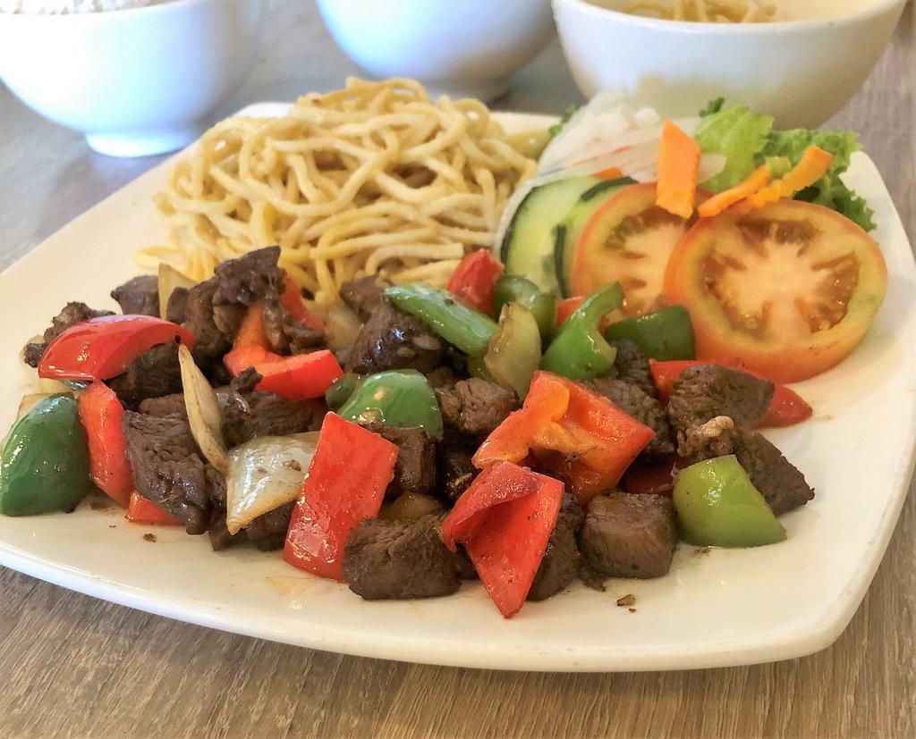  Bo Luc Lac Mi Toi · Stir-fried filet mignon beef cubes with garlic noodle and vegetables.