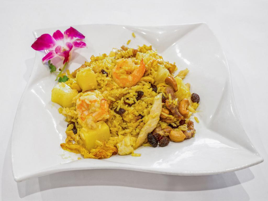 Tropical Fried Rice · Curry rice, meat or veggies, eggs, pineapple, cashews, and raisins on top.