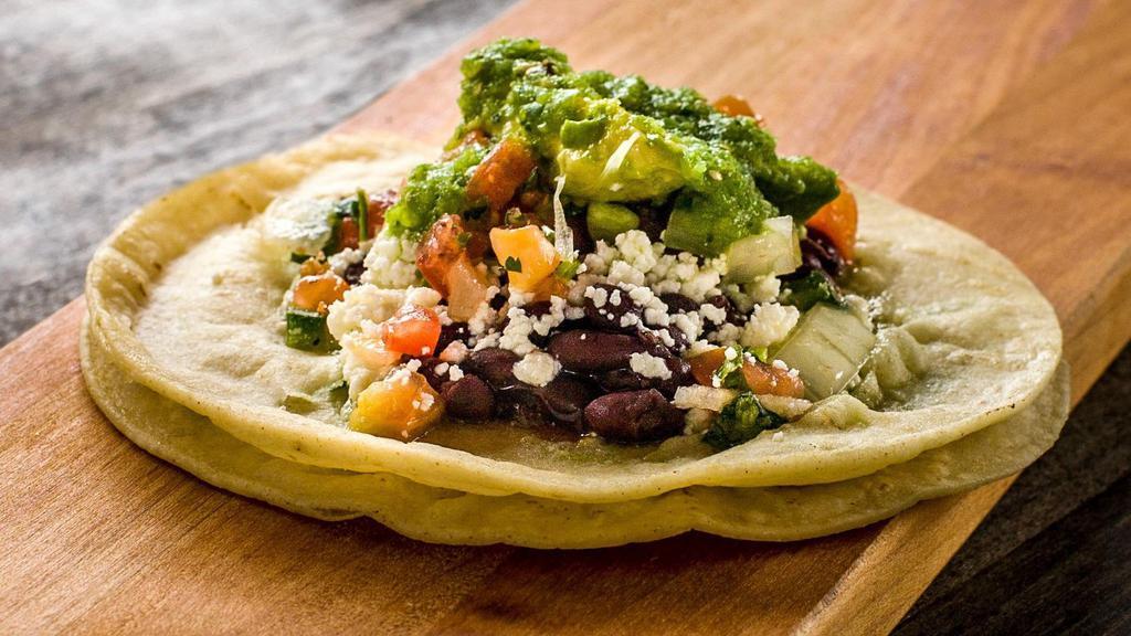 Aguacate con Queso Taco · Avocado, queso fresco, black beans, pico de gallo and salsa verde.