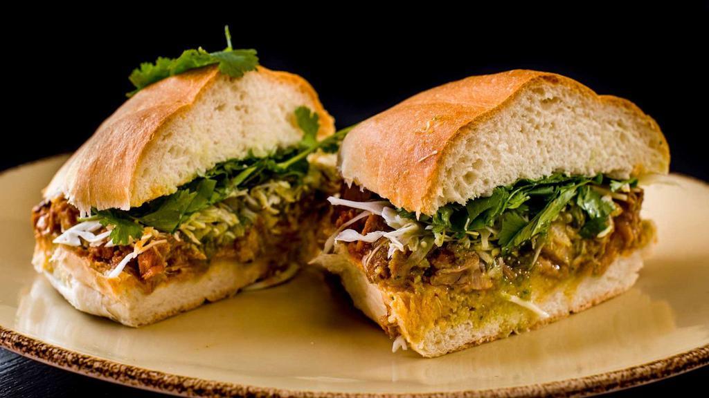 Carne Enchilada Torta · Pork enchilada, cabbage, salsa verde and cilantro. Traditional Mexican street sandwiches served on telera bread with refried bean spread.