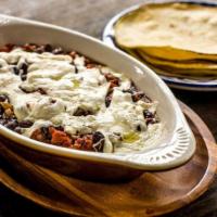Queso Fundido · Poblano peppers, black beans, onions and melted queso oaxaca with soft tortillas (with chori...
