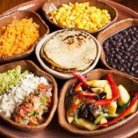 Plato Don Vegetariano · With roasted vegetables and corn. Served with rice, beans, guacamole, pico de gallo,queso fr...