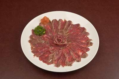 BF SASHIMI · 4oz Center Cut Certified Angus Beef filet mignon, seared and thinly sliced. Served with our house made. Joy Sauce and green onions.