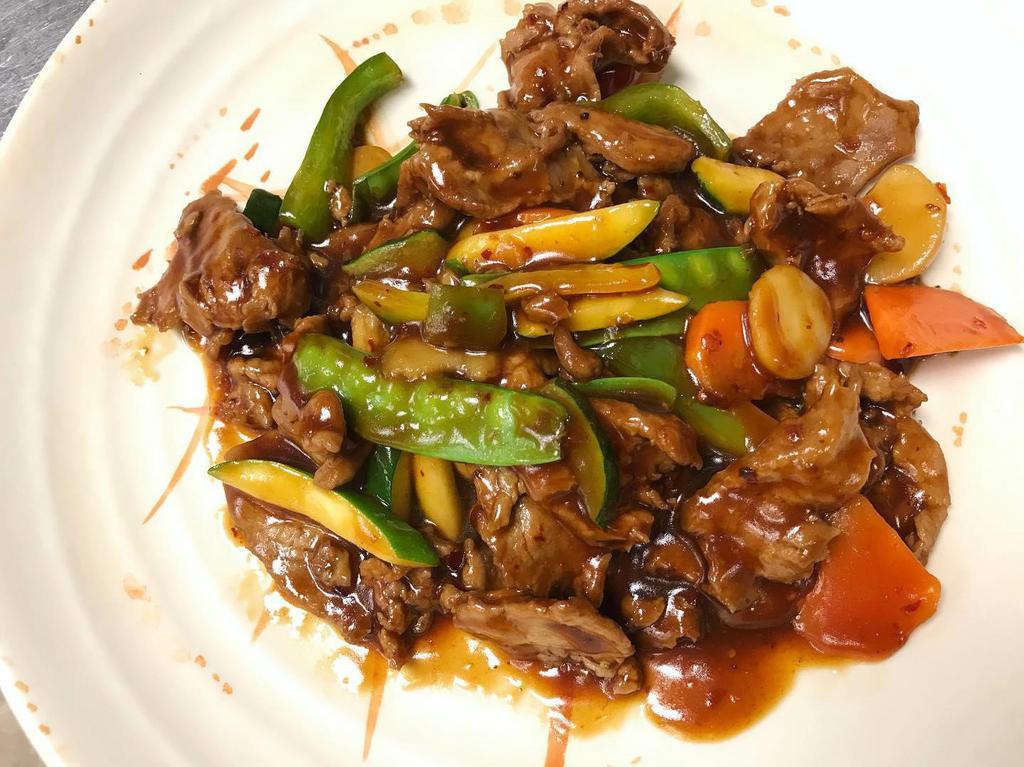Beef in Garlic Sauce · Slices of tender beef stir-fried with carrots, zucchini, snow peas, mushrooms and bell peppers in mild-spicy garlic sauce.