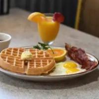 Waffle Combo · Crispy Belgian waffle topped with 2 eggs and your choice of 2 sausage links or 2 bacon strips.