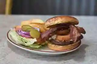 Western Burger · Topped with Swiss cheese, crisp bacon strips, and breaded onion rings. 1/3 lb. of 100% lean ground beef charbroiled.