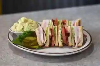 Clubhouse Sandwich · Triple Decker of ham, turkey, bacon, lettuce, and tomato on toasted white bread.