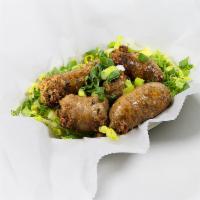 Cajun Boudin Sausage · Savory Cajun Seasoned Sausage Links made with Chicken and Pork, served over a bed of fresh R...