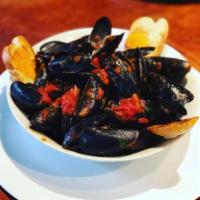 Mussels · White garlic, fra diavolo or chorizo topped with Parmesan cheese and a side of garlic toast.