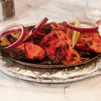 Tandoori Chicken · Chicken marinated in creamy yogurt sauce and cooked in a clay oven for smoky flavor.
