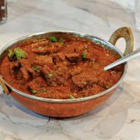 Lamb Curry  · New. Cubes of lamb cooked in onion and tomato sauce with traditional Indian curry.