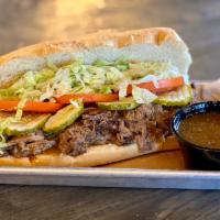 Debris with Side of Gravy (Braised & Shredded Beef) · Served dressed with shredded iceberg lettuce, tomato, and dill pickles. 