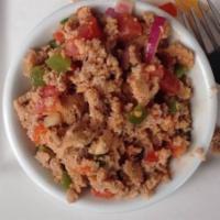 Timatim Fitfit · Injera mixed with diced tomatoes onions, jalapeno peppers, garlic and olive oil hint of spic...
