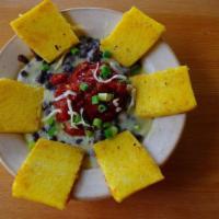 Polenta with Black Beans · Homemade Parmesan polenta and black beans baked with cheddar, topped with salsa, and green o...