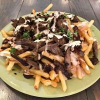 Shawarma Fries · Fries, topped with tri tip or chicken shawarma and tahini and garlic sauce.