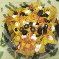 Classic Nachos  · Cheddar cheese, cheese sauce, sour cream, black olives, tomatoes and jalapenos.
