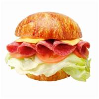 36. Salami and Cheese Croissant Sandwich · Served on large croissant with American cheese, lettuce, tomato, and mayonnaise. Dill pickle...