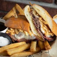 #73 Brisket Dip · Smoked provolone, crispy onion straws, toasted French Roll, Au Jus.