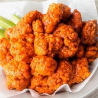 20 Boneless · 20 Boneless Wings tossed in your choice of up to 2 sauces.  Served with celery and ranch or ...
