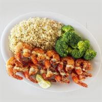 Island Grilled Shrimp · Grilled shrimp skewers are perfectly seasoned in a smoky mesquite rub, drizzled in garlic pa...