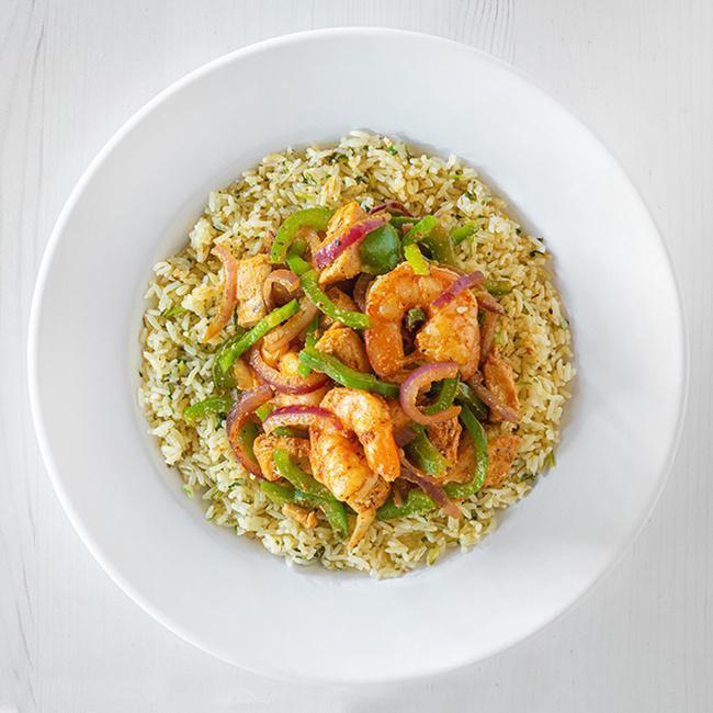 Calypso Seafood Bowl · This goddess bowl features cajun seasoned shrimp and mahi mahi sauteed with onions and peppers in a ginger sauce. Served on a bed of cilantro lime rice. (960 cal.)