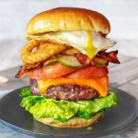 Hangover Burger · A hangover killing combination of crispy bacon, fried egg, jumbo onion rings, tomatoes, ched...