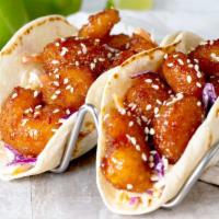Firecracker Shrimp Taco · Our famously fried shrimp is tossed in sweet'n'spicy firecracker sauce over garlic ginger sl...