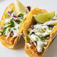 Baja Fish Taco · Grilled mahi mahi is rubbed with cajun seasoning, topped with shredded cabbage, lime crema a...