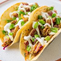 Ahi Tuna Taco · Perfectly seared at medium rare, our tuna tops Asian slaw in two flour tortillas, finished w...