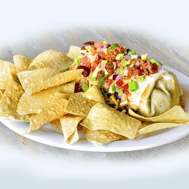 Smothered Burgerito · A seasoned all-beef pepper jack cheeseburger chopped and wrapped in a flour tortilla and topped with warm queso, chili, shredded cheddar jack cheese, diced tomatoes and green onions. Served with a side of tortilla chips. (1630 cal.)