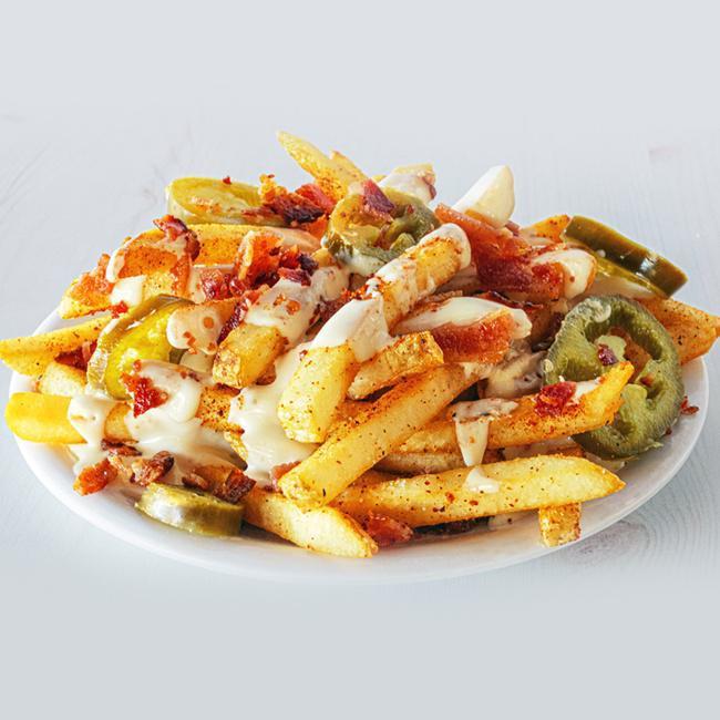 Side Bacon Jalapeño Cheese Fries · Our natural cut fries tossed in a spicy seasoning, smothered in warm queso, topped with crumbly bacon and jalapenos. (720 cal.)