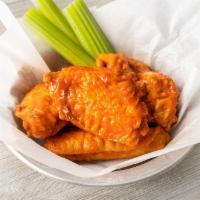 Kid Wings (4) · Cooked to order, four natural wings. Served with 1 sauce, celery sticks and your choice of r...