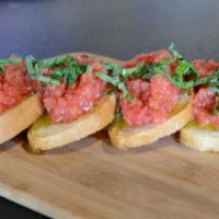 351. Bruschetta · Our homemade bread sliced and baked to a perfect crust and topped with marinated cherry toma...