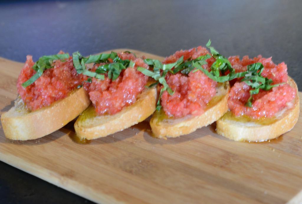 351. Bruschetta · Our homemade bread sliced and baked to a perfect crust and topped with marinated cherry tomatoes and basil.
