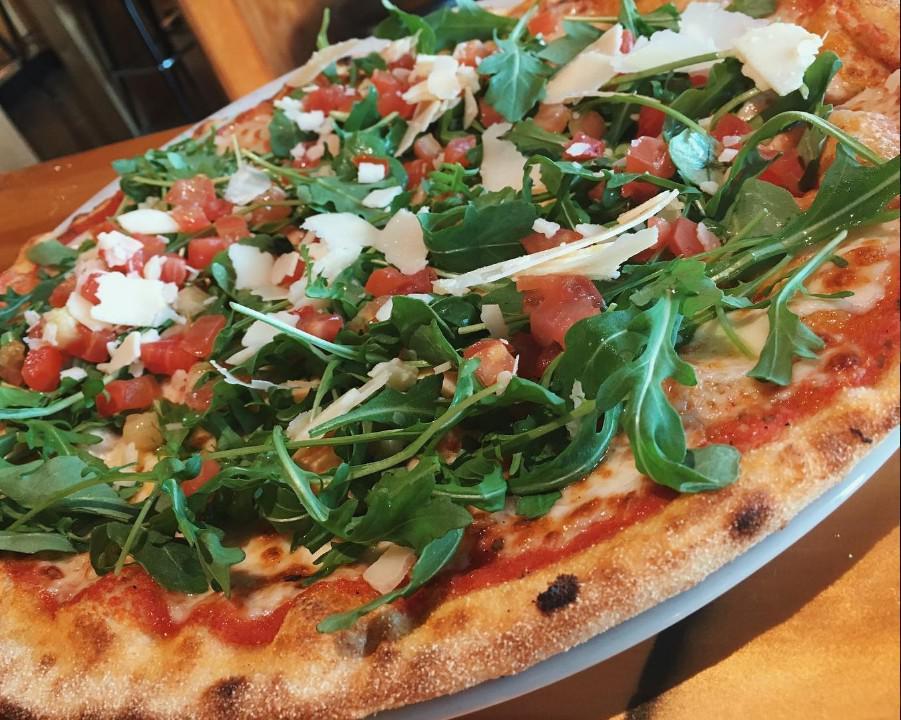 4. Moderna · Topped with fresh arugula, diced tomatoes and shaved Grana Padano cheese.