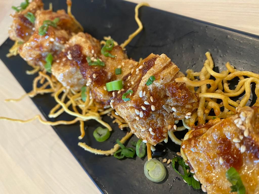 Crispy Tofu Bite · Tossed with special ginger garlic sauce, sesame seed, green onion along with crispy ramen noodles