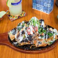 Mission Cantina Nachos · Corn chips, cheese and black beans piled high and oven-baked. Served on a hot skillet with g...