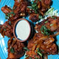Alitas de Pollo · 8 pieces chicken wings, flash-fried and tossed in a tangy cayenne pepper reduction. Served w...