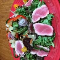 Ahi Tuna Salad  · Pepper-crusted ahi tuna, seared rare and served over a bed of champagne orange vinaigrette g...