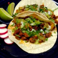 Al Pastor Tacos  · Spiced pork pineapple. Adobo marinated pork, pineapple and spices, topped with diced onions,...