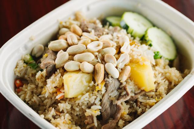 F2. Pineapple Fried Rice · Jasmine rice stir fried with chicken or beef, pineapples, carrots, scallions, onions, green peas, golden raisins and roosted peanuts.