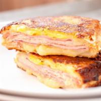 Monte Cristo Sandwich · Challah bread french fries toast topped with ham, turkey and melted Swiss cheese.