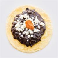 Frijoles con Queso · Black refried beans served with queso fresco and topped with chipotle Chile. Spicy. Gluten-f...