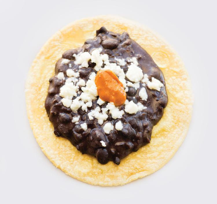 Frijoles con Queso · Black refried beans served with queso fresco and topped with chipotle chile.