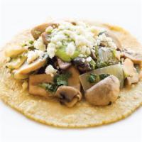Hongos con Cilantro · Mushrooms cooked with cilantro and onions. Served with green serrano chile and queso fresco.