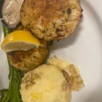 Crab Cakes  · 2 jumbo lump crab cakes, served with broccolini and mashed potatoes, with a side of remoulad...